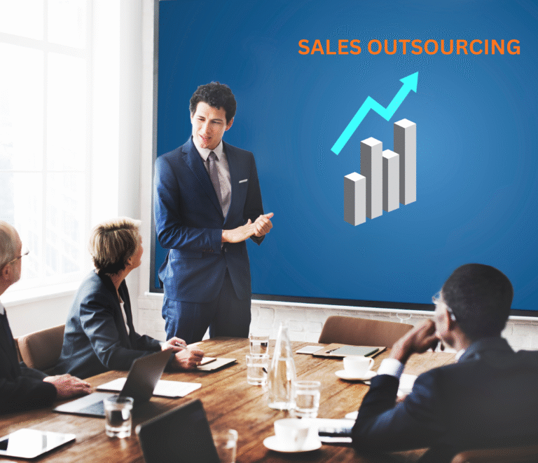 Business professional presenting a sales outsourcing strategy with growth chart on screen to colleagues in a conference room.