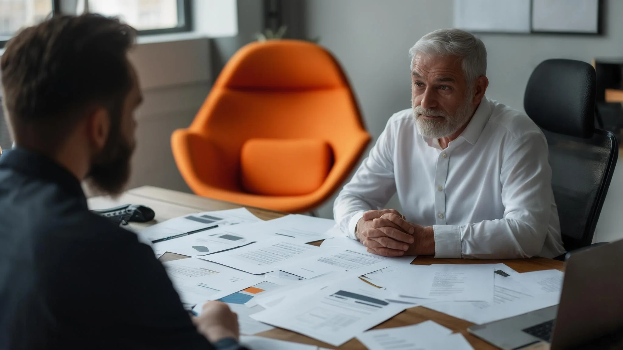DevOps engineer reviewing pipeline and cluster dashboard data on dual monitors in a bright modern office, orange coffee mug on the desk