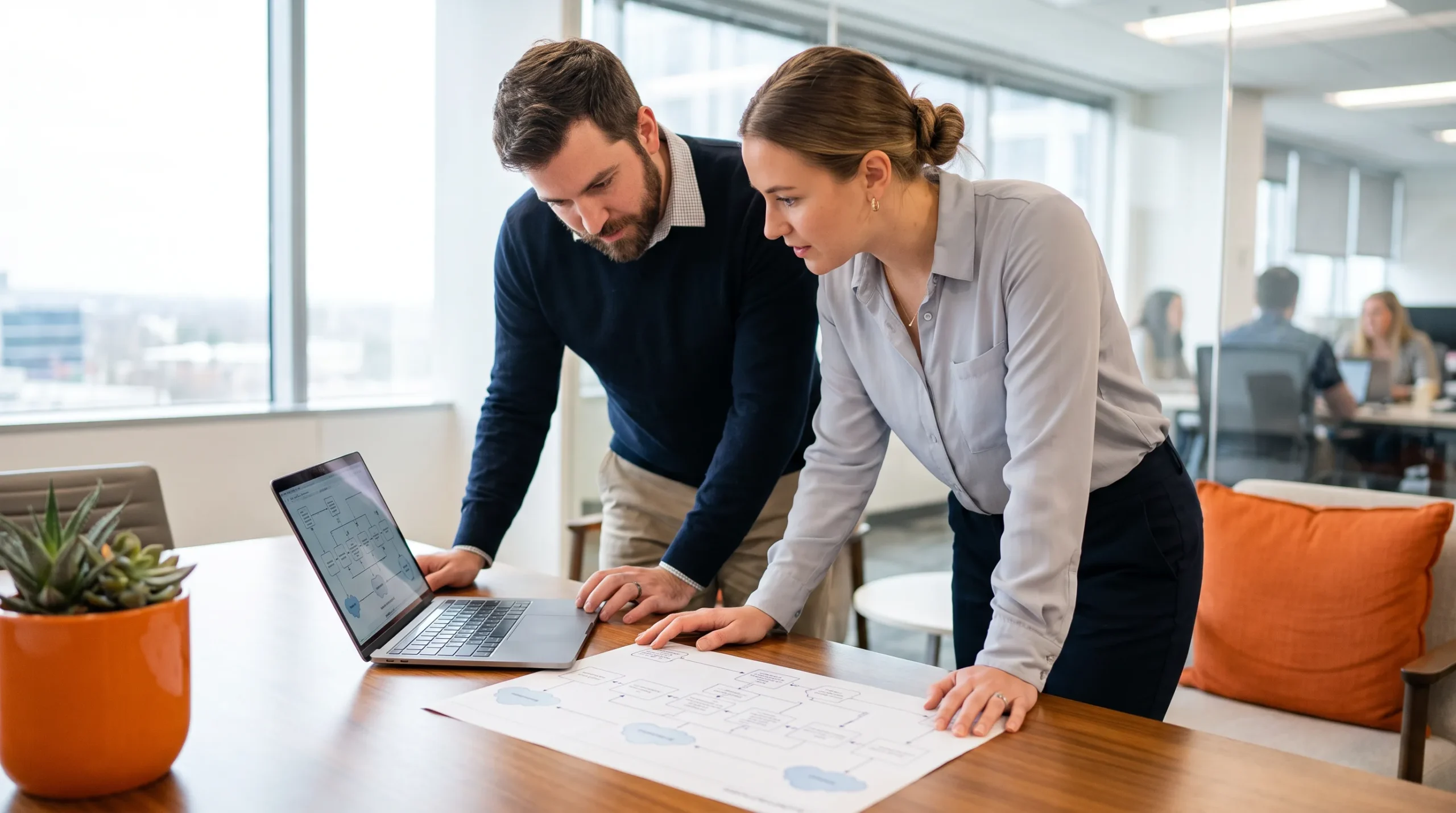 Two engineers reviewing an agent orchestration architecture diagram at a conference table