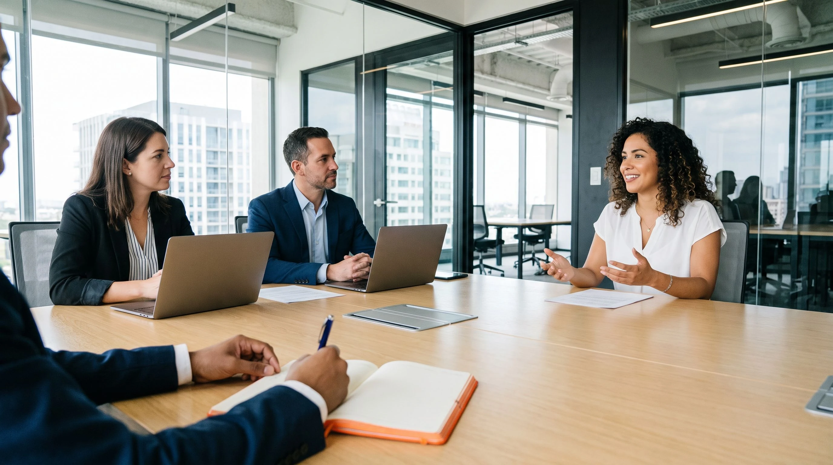 Engineering manager conducting a structured AI engineer technical interview in a bright modern conference room