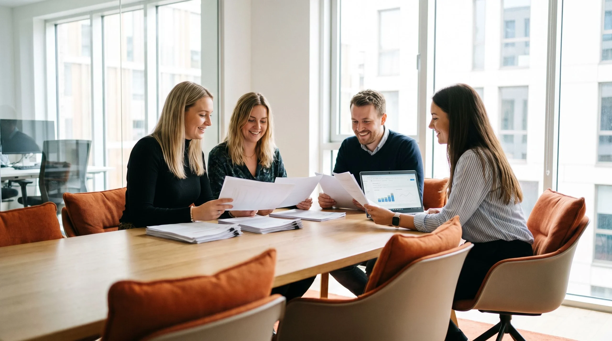 HR team reviewing customer service job description templates on a shared screen in a modern meeting room