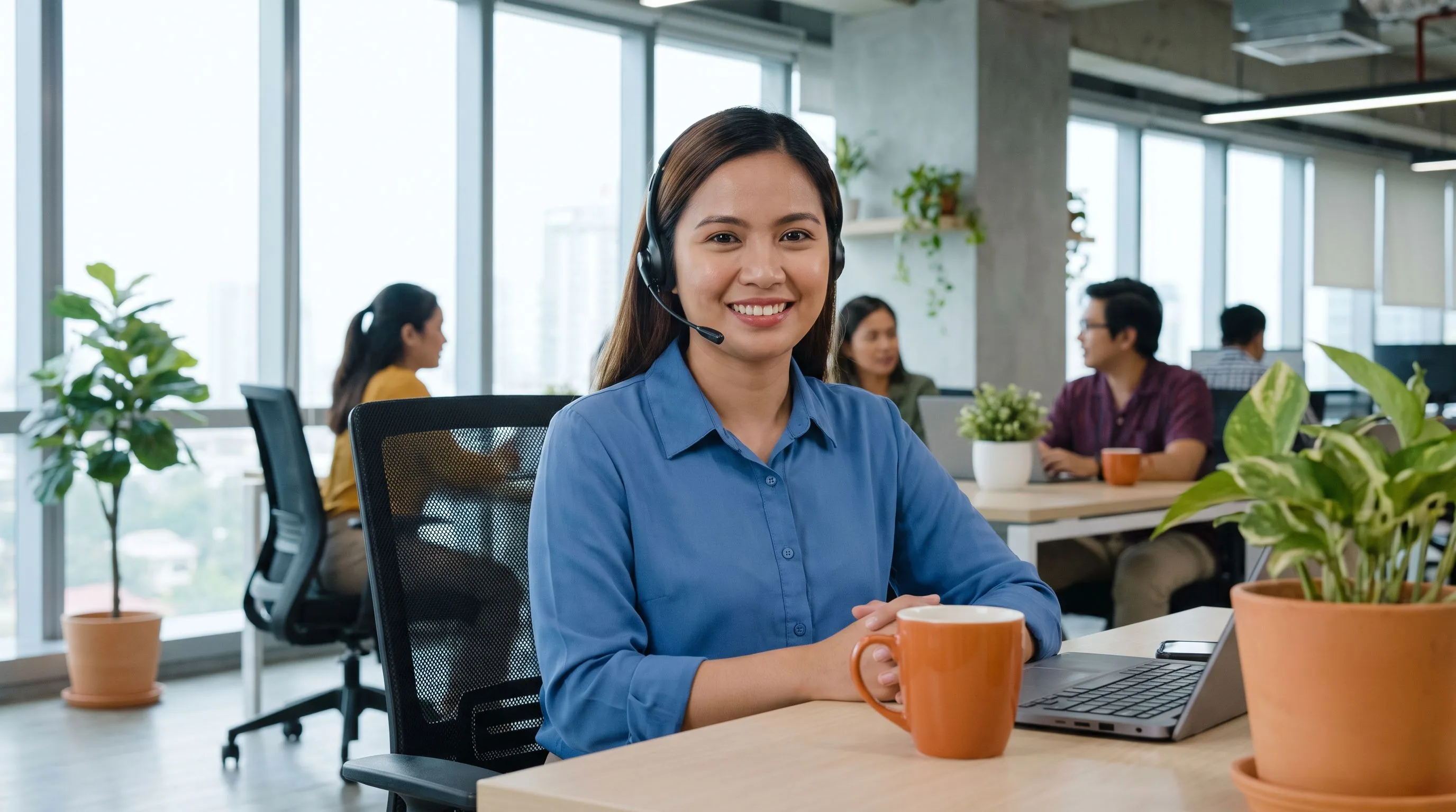 Offshore customer support representative on headset in modern professional office