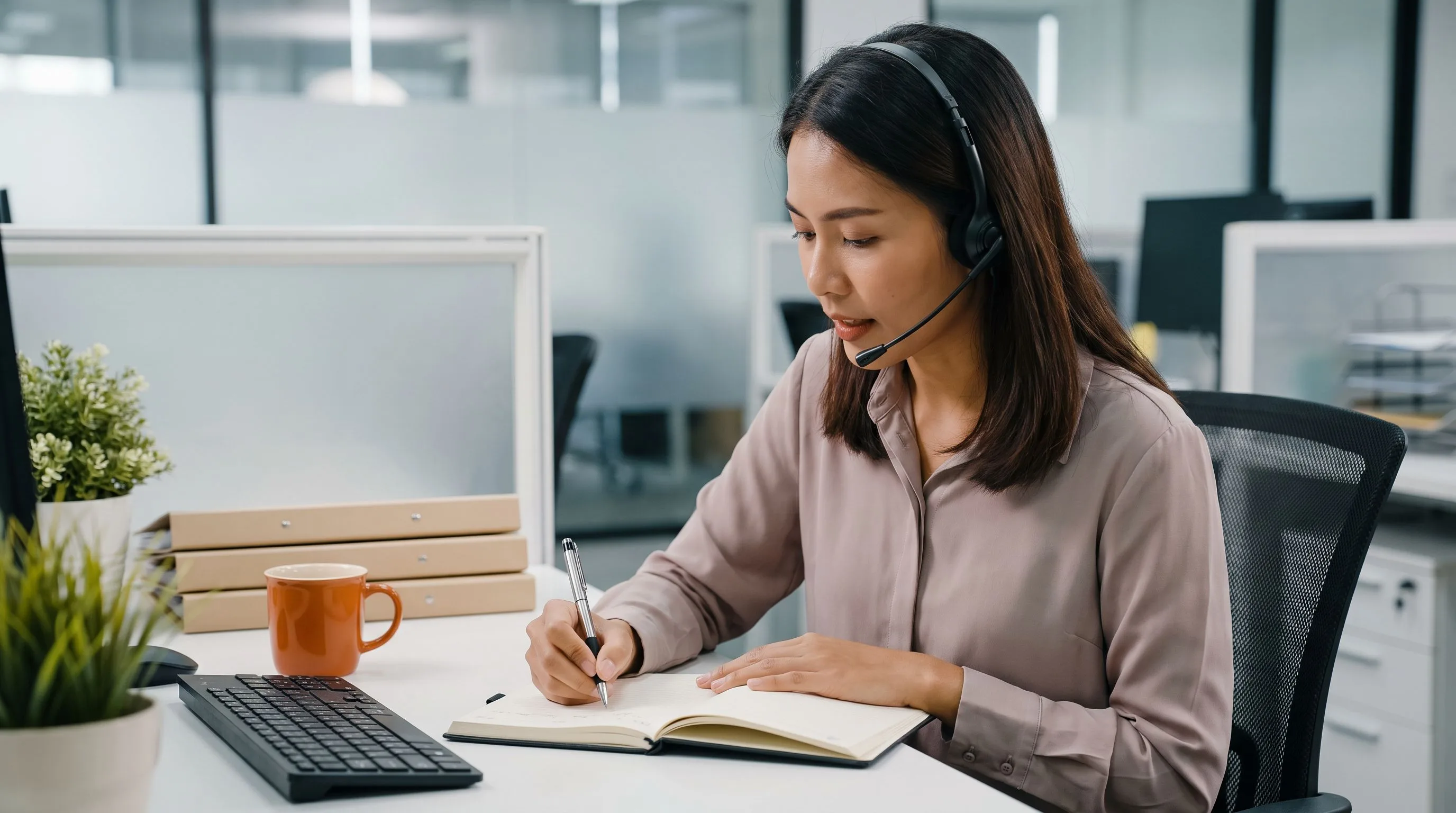 Offshore customer support professional reviewing and organizing work tickets on a dual monitor desktop setup