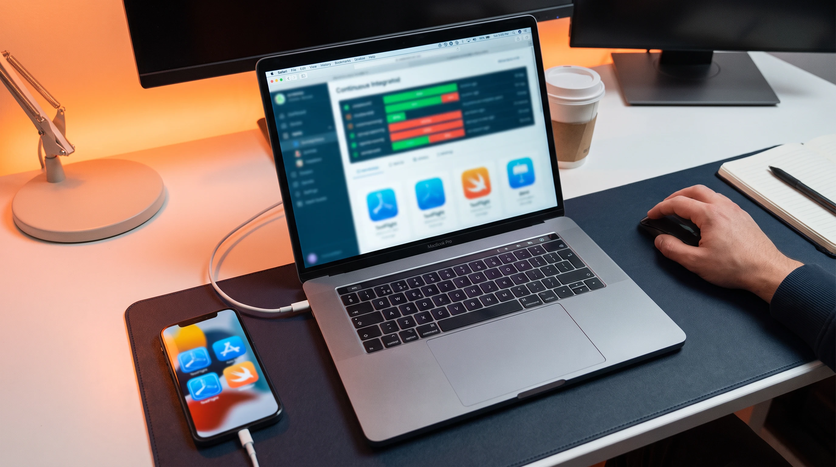 iPhone connected to a MacBook showing a CI/CD testing dashboard for an iOS app before a TestFlight release