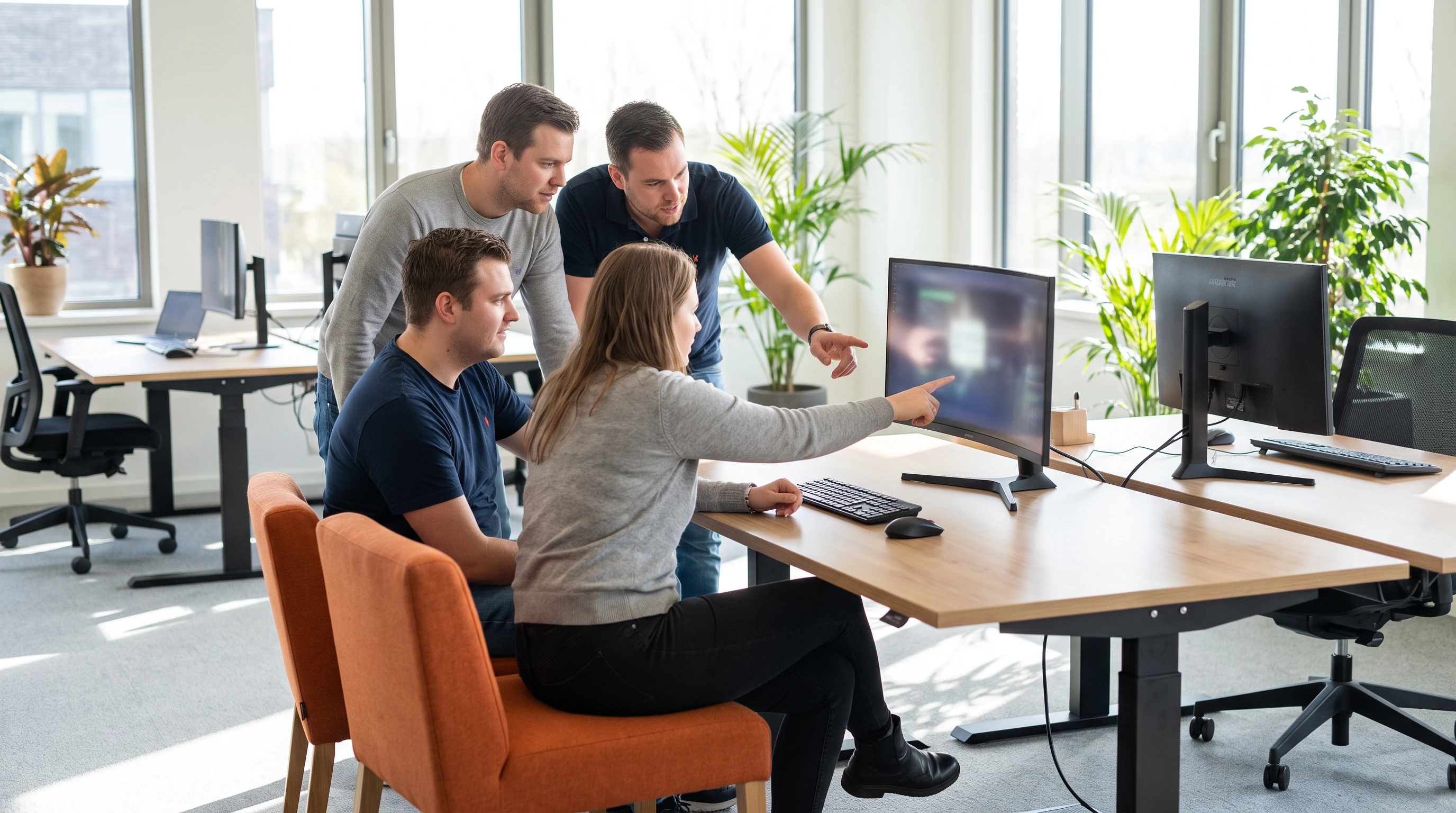 Small team of IT support specialists collaborating around a desk in a support center