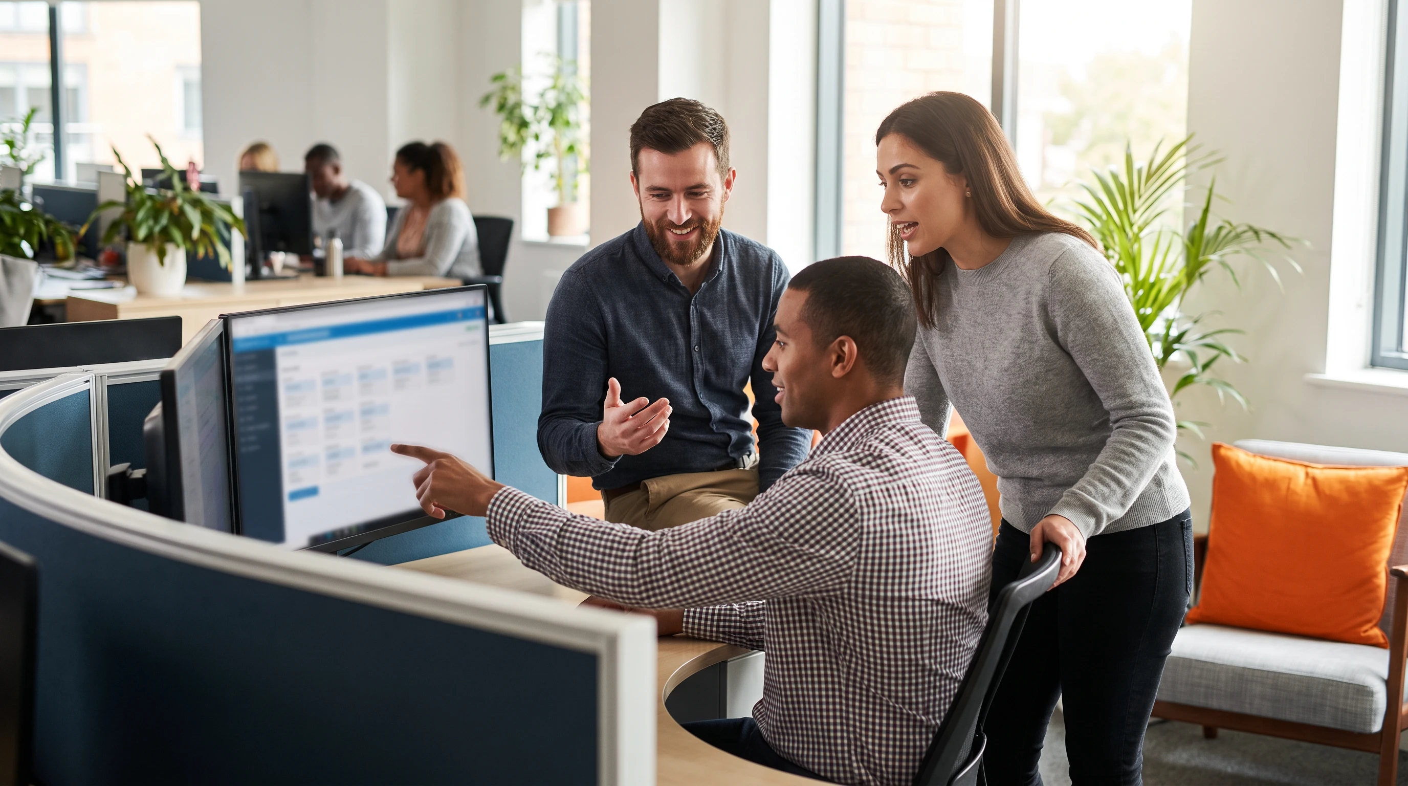 IT support team reviewing a shared ticket queue dashboard together in a modern office