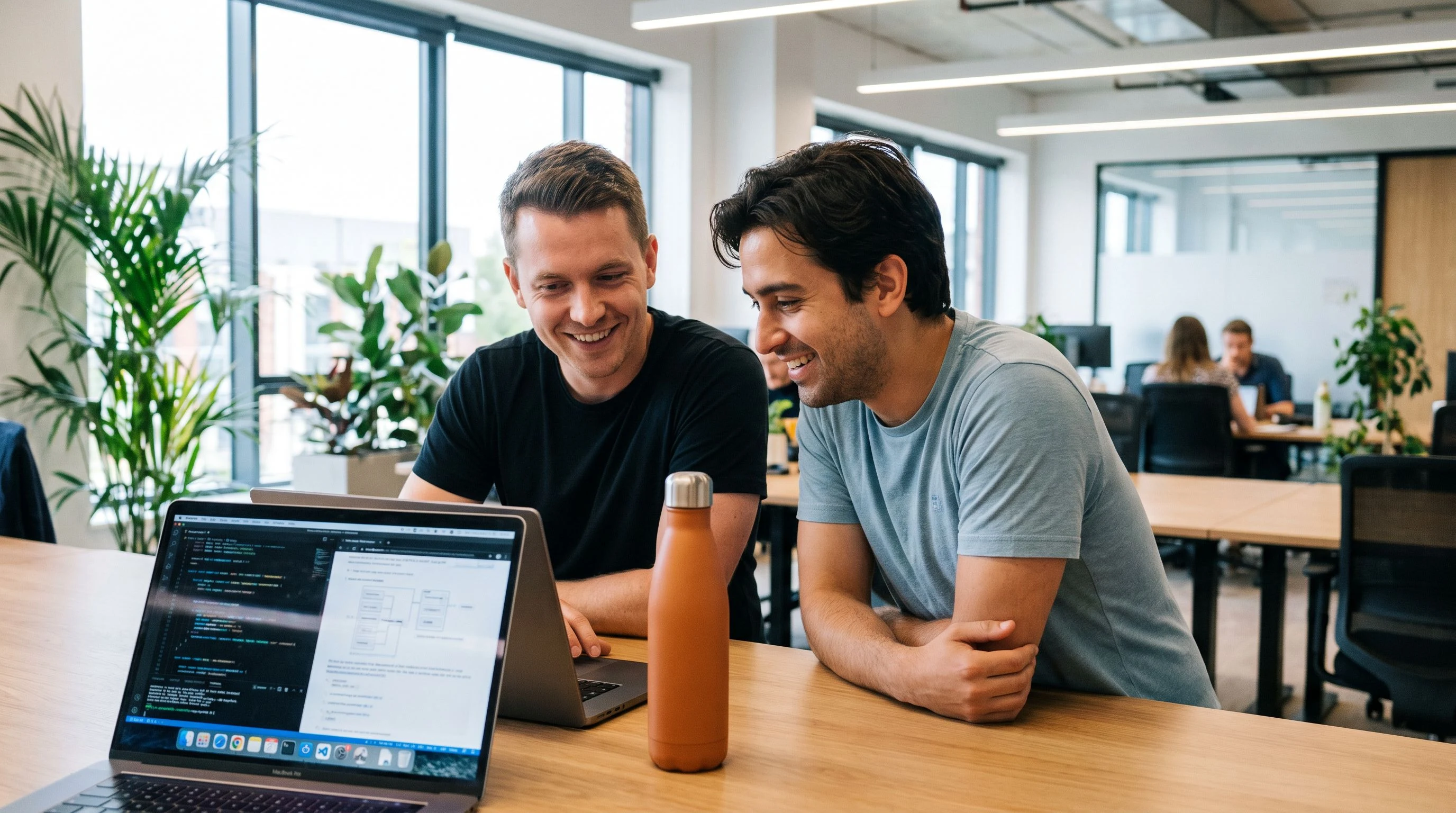 Interviewer and candidate reviewing model architecture notes on a laptop screen together