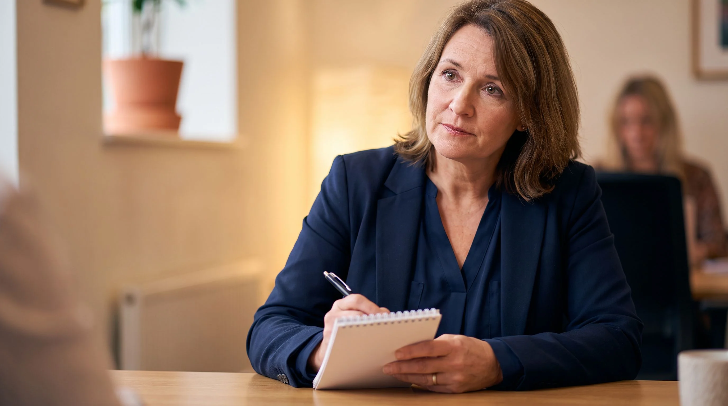 Two interviewers using a structured scorecard to evaluate an offshore recruiter candidate during a live interview session