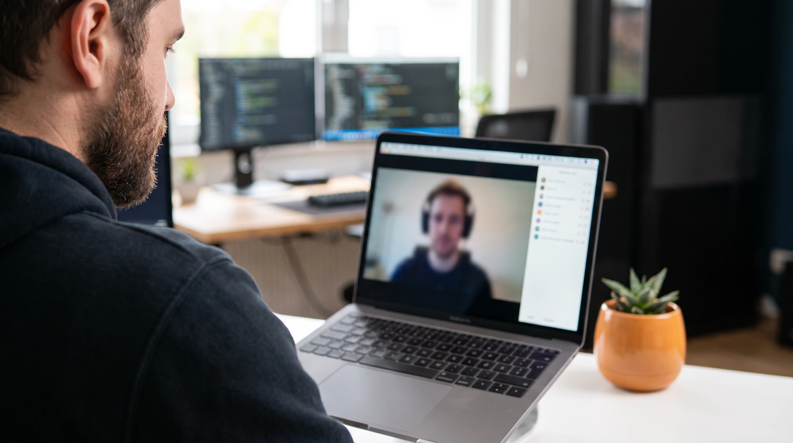 Developer on a video call with a remote offshore engineering teammate
