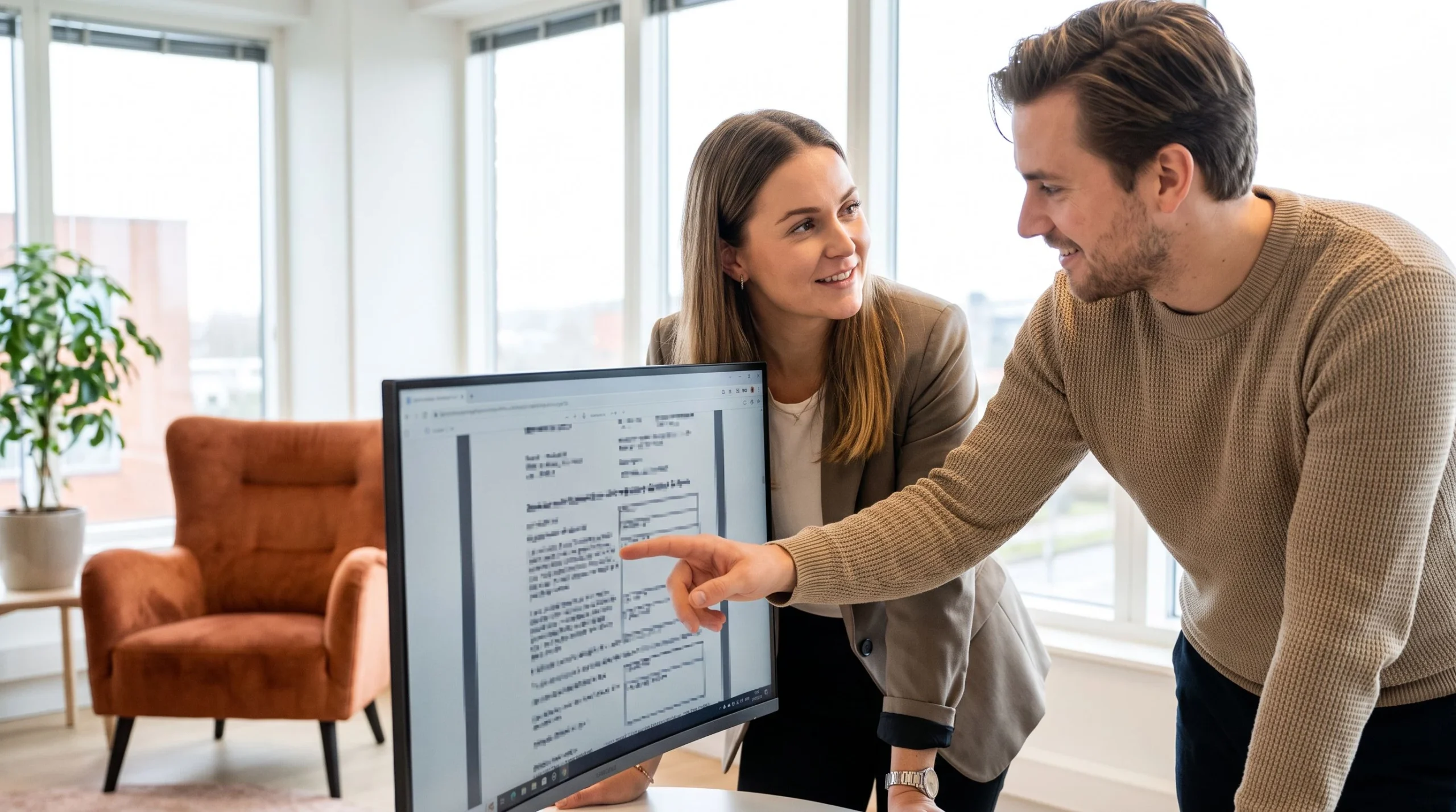 Two colleagues reviewing an AI-assisted scanned document together on screen