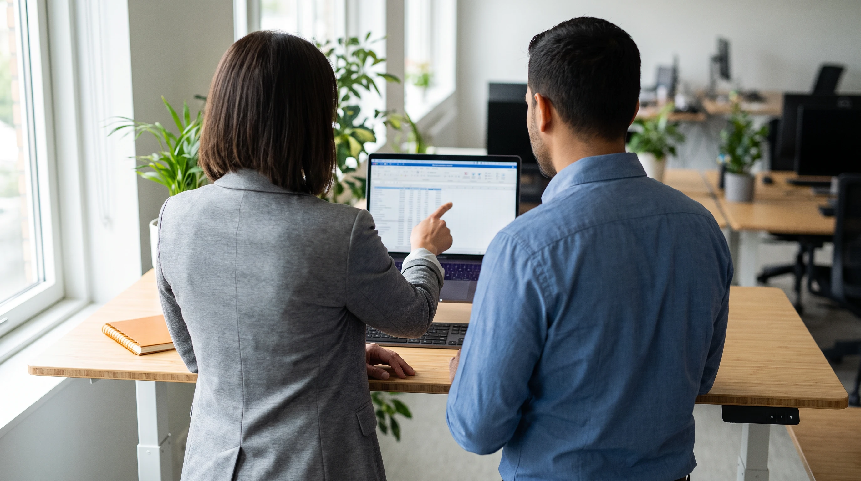 Two colleagues reviewing a data entry quality control pass together