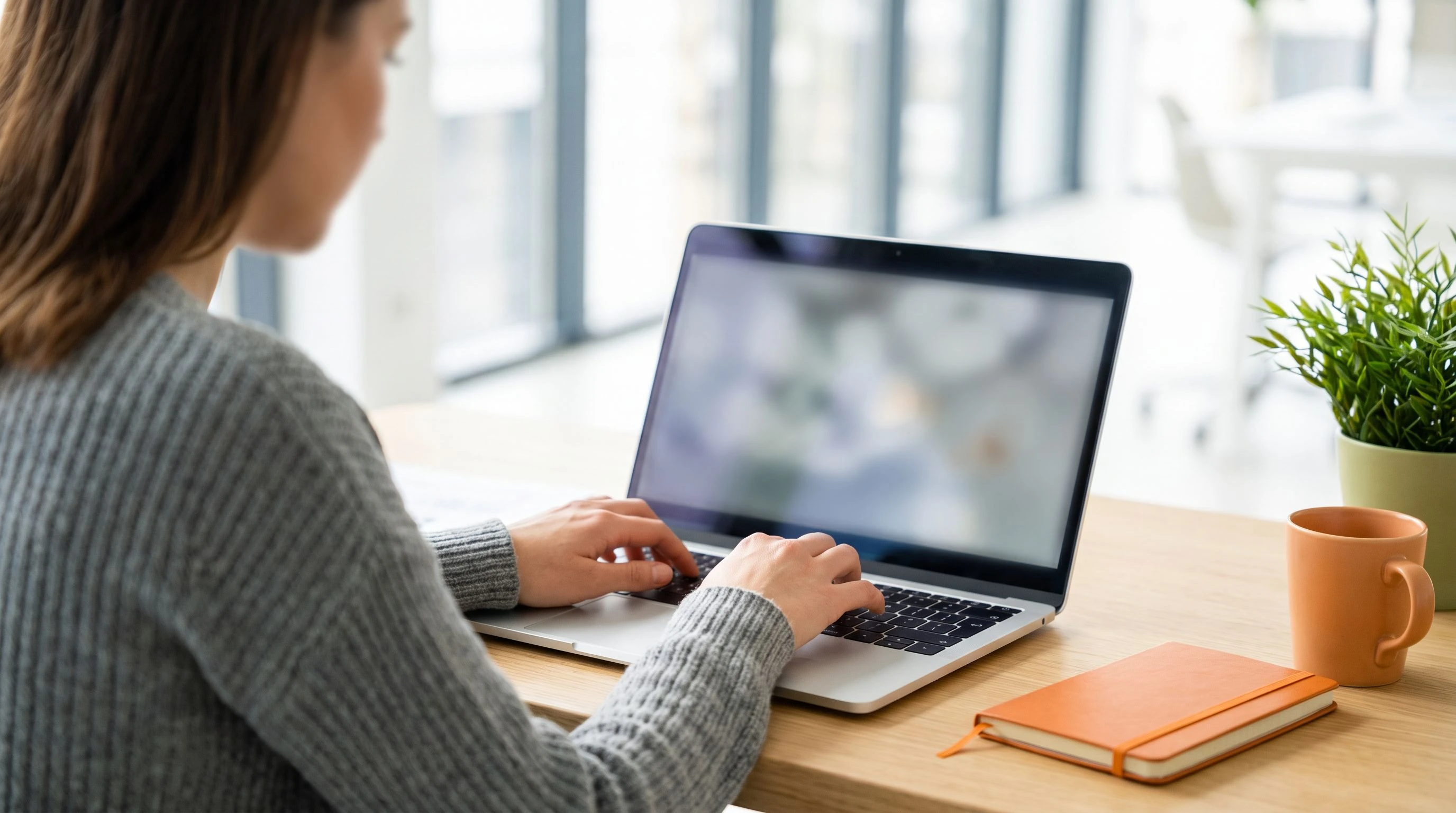 Professional entering data into a laptop, illustrating data entry and data processing outsourcing services pricing