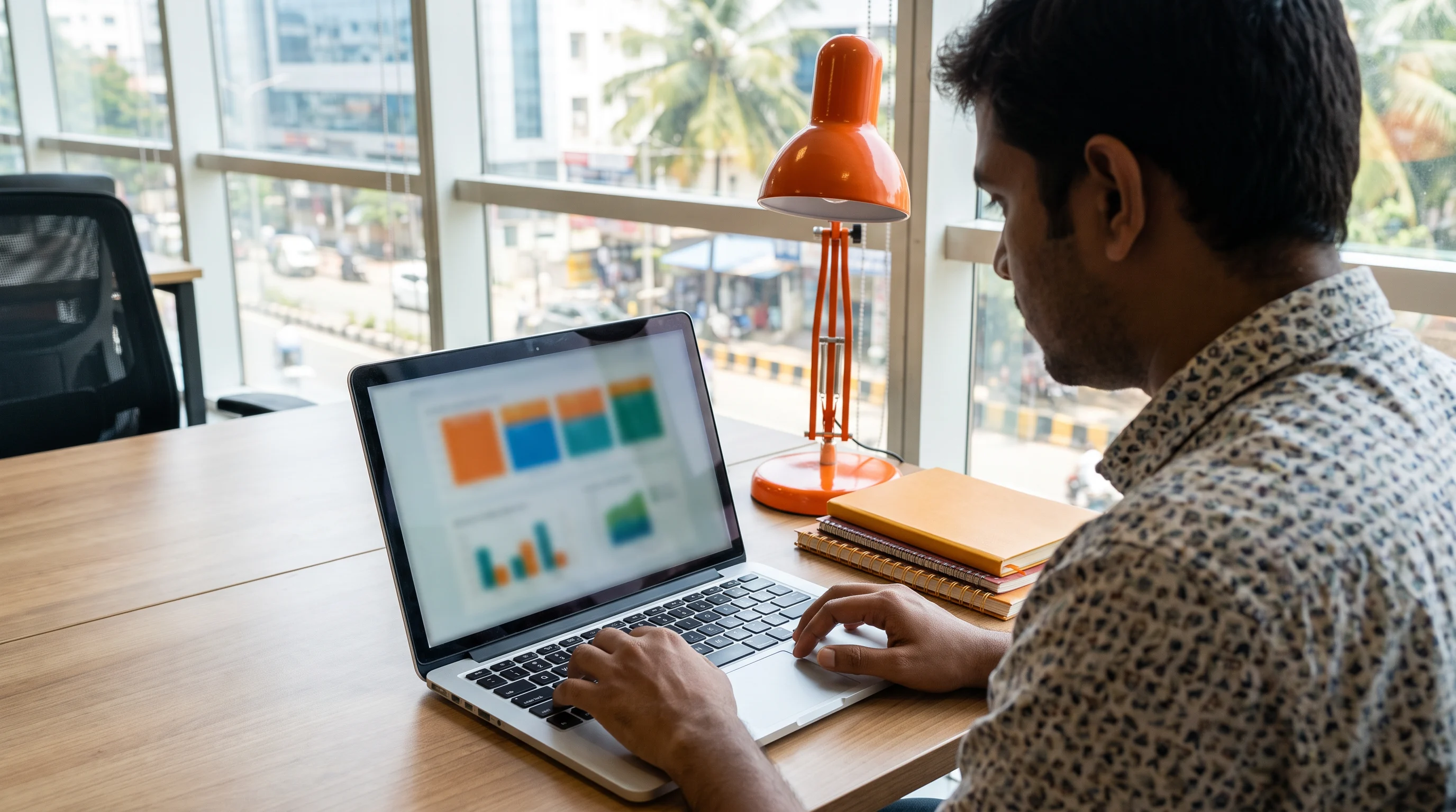 Offshore accountant working at a laptop reviewing financial data for a US client