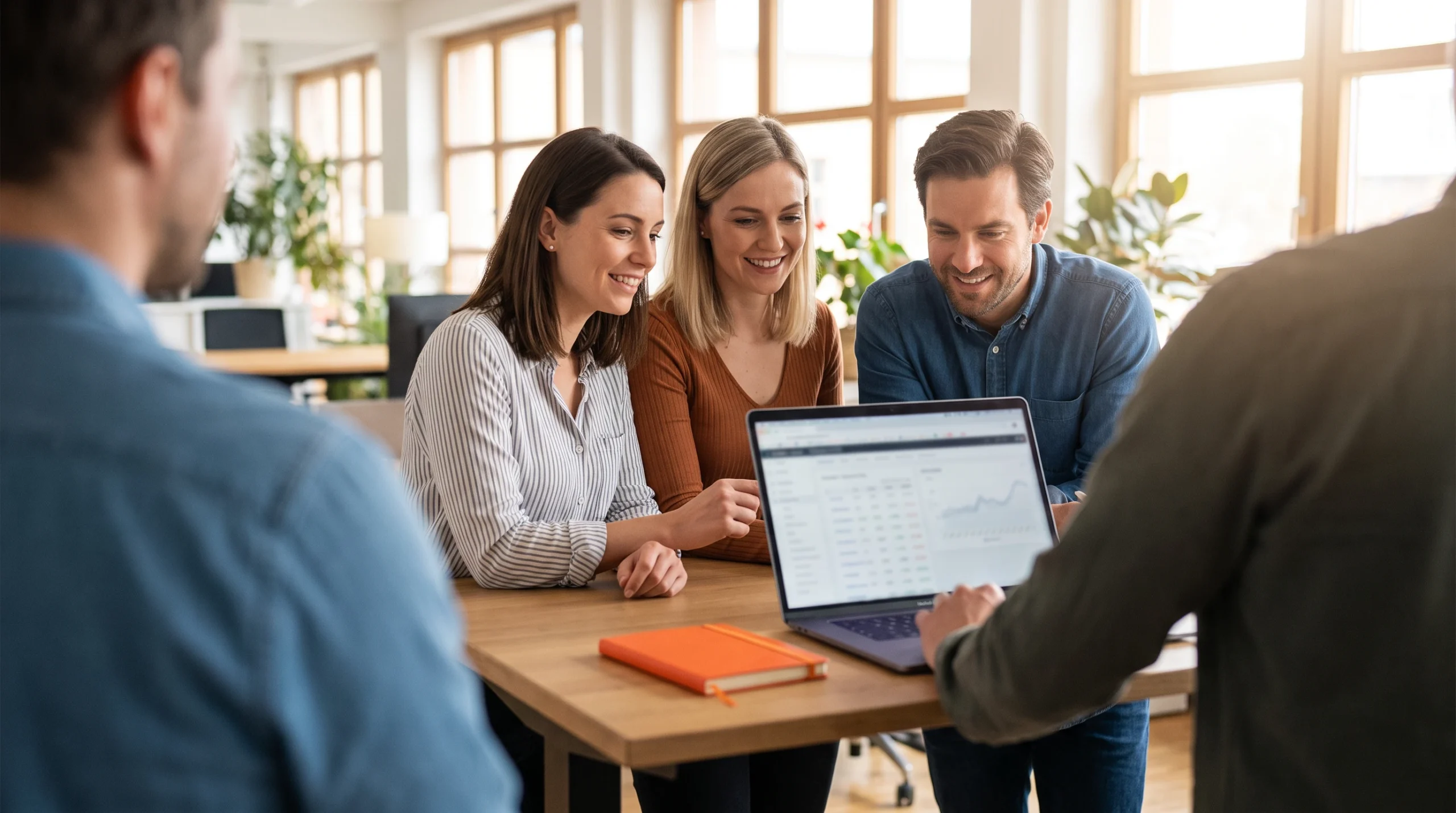 In house vs outsourced insurance BPO services, claims team comparing files and laptop